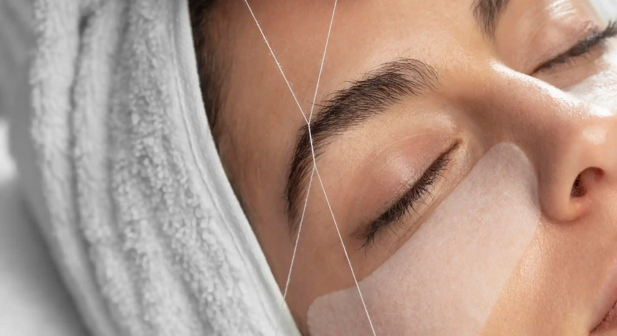 waxing and threading technician shaping client's brows in Melbourne